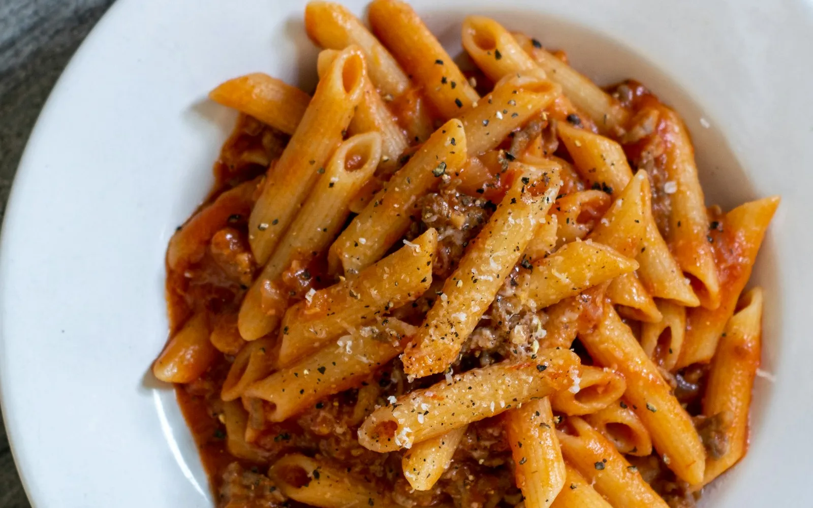A bowl of creamy pasta with roasted tomatoes