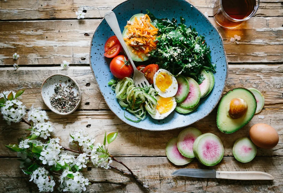 A colorful vegetable grain bowl on a wooden table